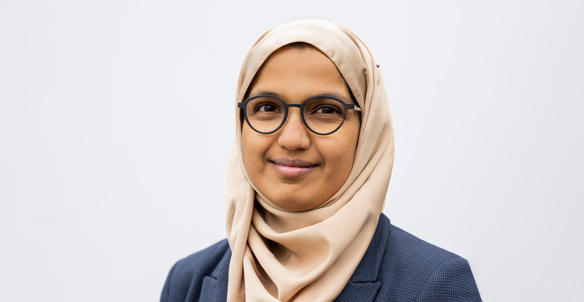 Headshot of a member of Hightown's Board, Zeena Farook. She is young and is wearing glasses and a blue checked blazer. Headshot of a member of Hightown's Board, Zeena Farook. She is young and is wearing glasses and a blue checked blazer.