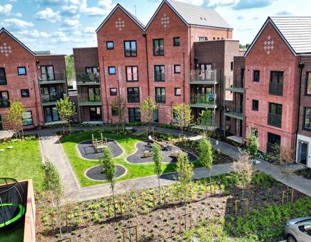 An elevated view showing the play area behind the apartments