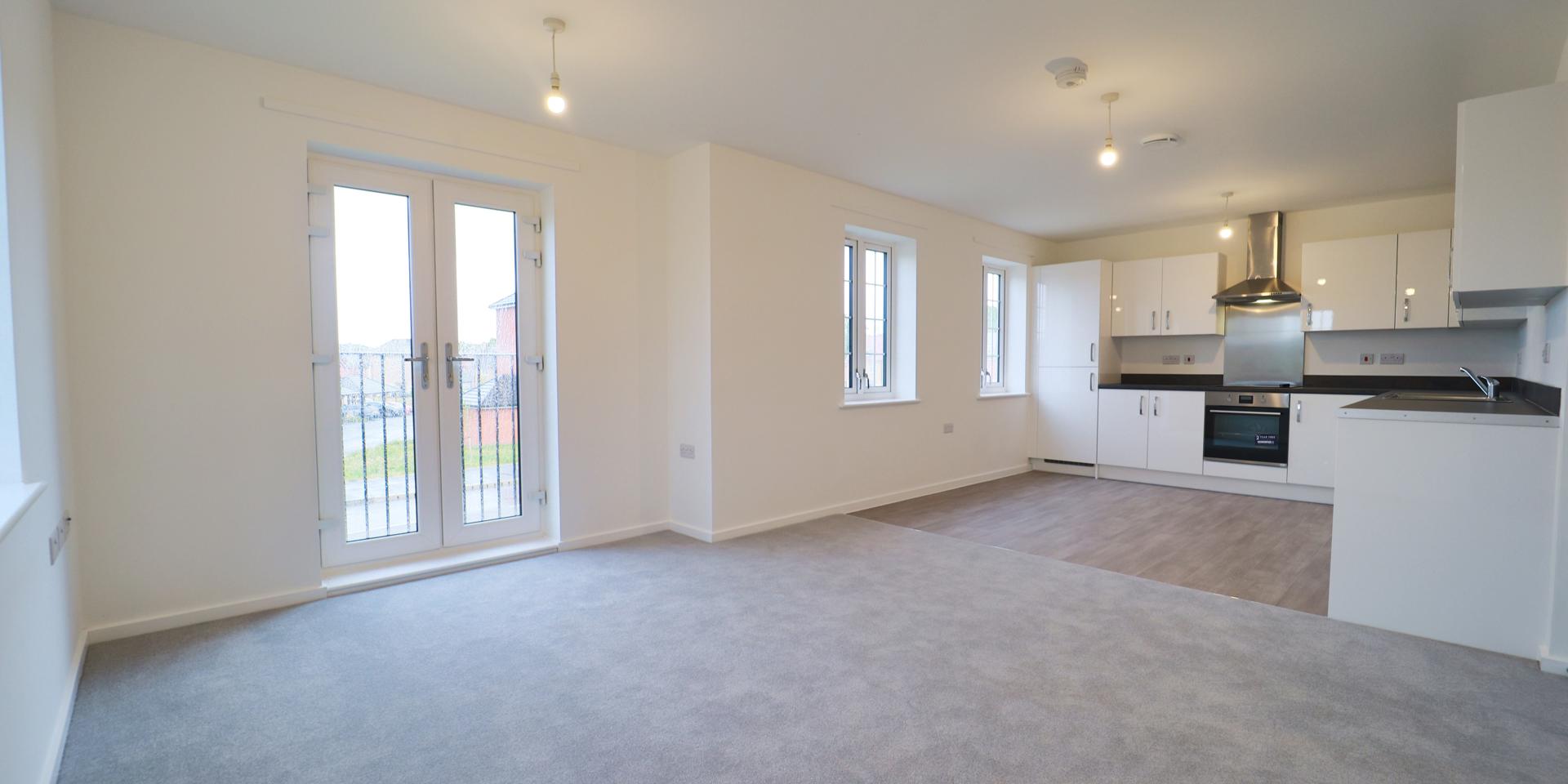 The living area is open plan to the kicthe/diner and has a Juliette balcony and window.