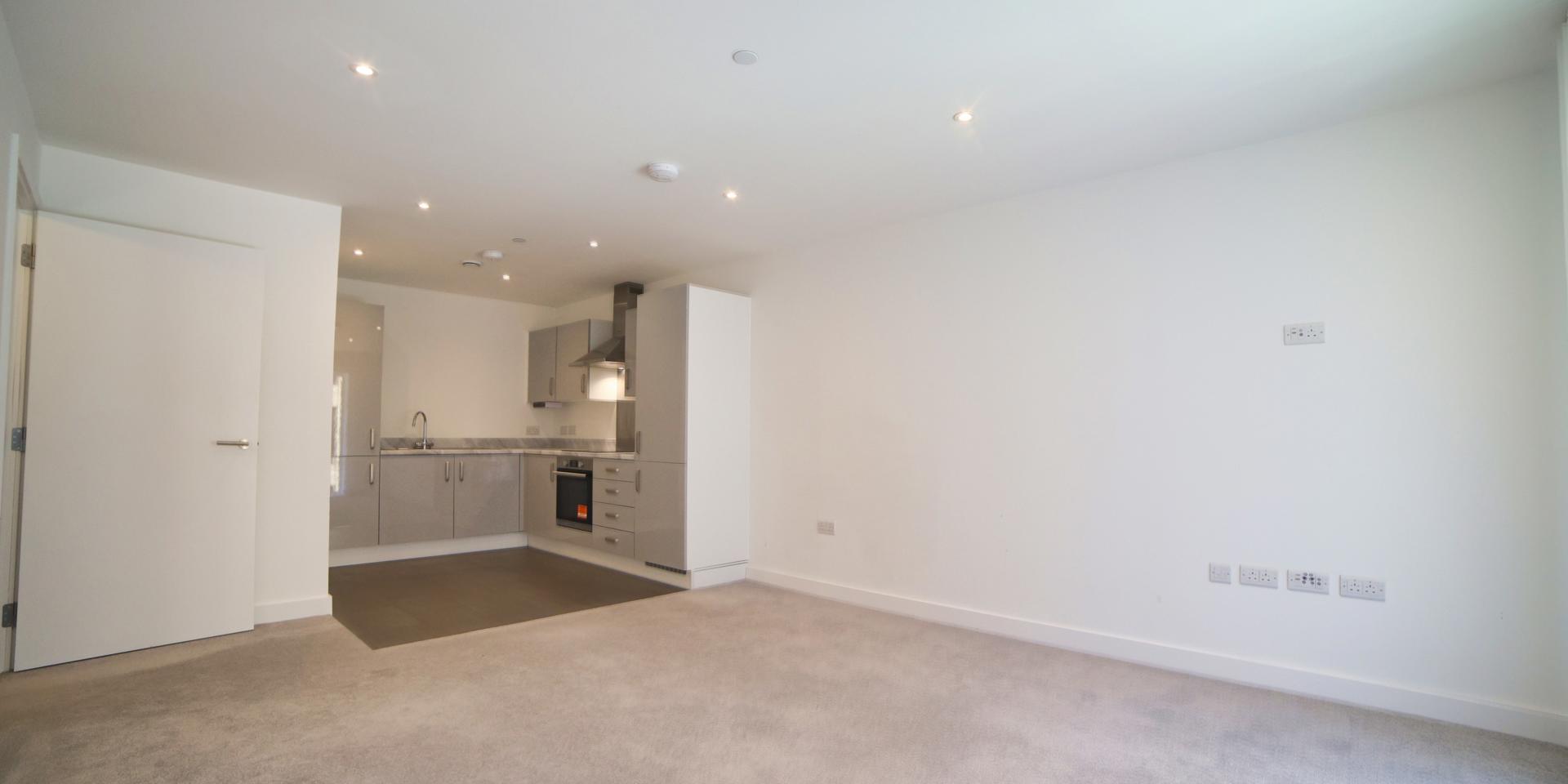 The kitchen is situated at the back of the living room