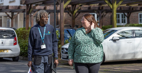 Property services inspector and a resident walking around the estate Property services inspector and a resident walking around the estate