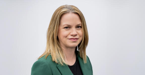 Headshot of Natalie Sturrock, Director of Housing. She is wearing a black top and emerald green blazer and has shoulder length blonde hair and green eyes. Headshot of Natalie Sturrock, Director of Housing. She is wearing a black top and emerald green blazer and has shoulder length blonde hair and green eyes.