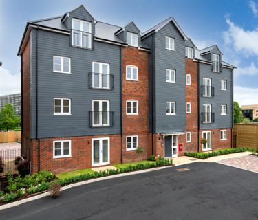 Newbuild flats. They are grey and brick and some have Juliet balconies.