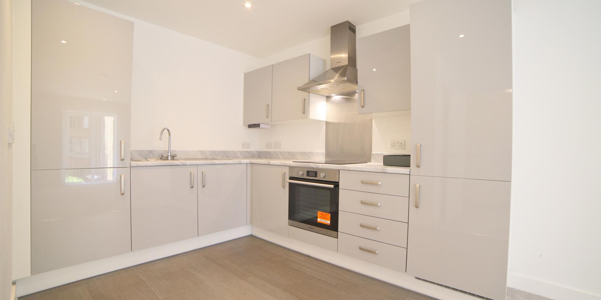 The kitchen units are grey gloss