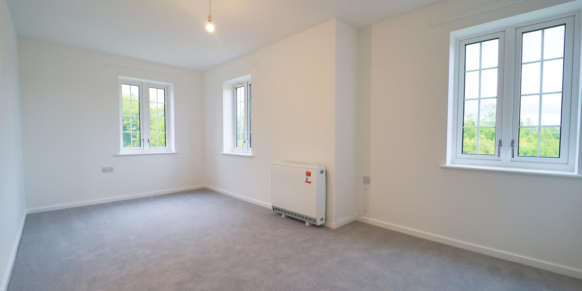 The second bedroom has three windows and is dual aspect