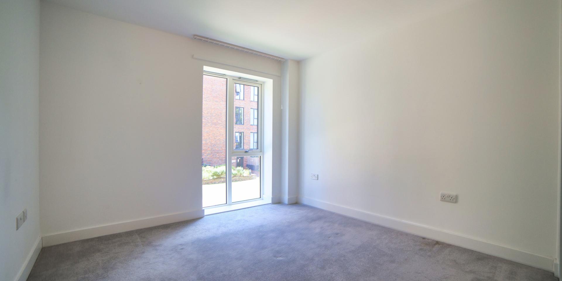 The window in the bedroom is almost floor to ceiling