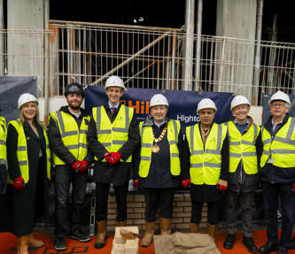 Hightown staff and others taking a group photo at Broadwater Road's bricklaying