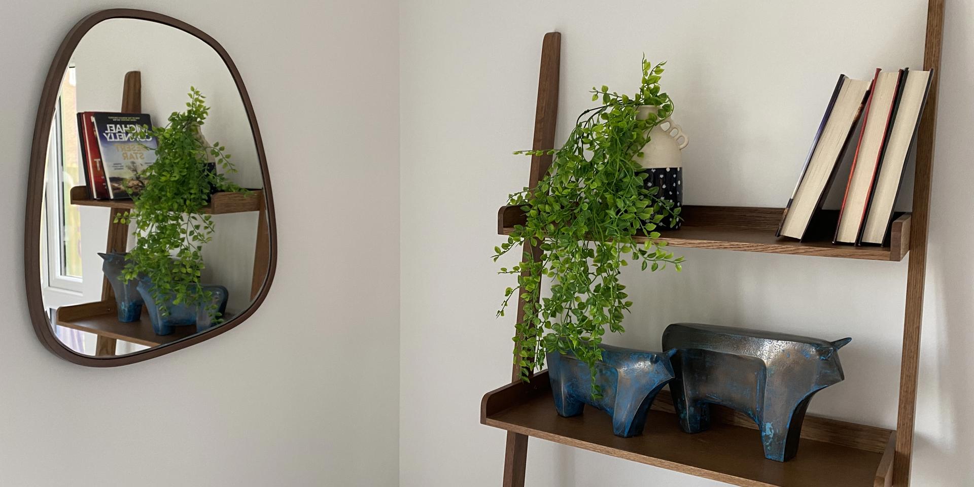 A stock image of a ladder shelving unit with ornaments on it